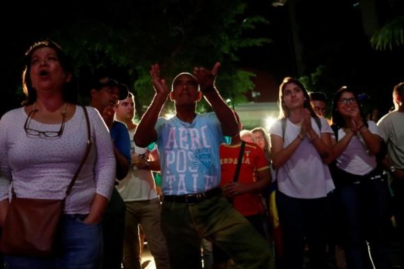 Opposition supporters react while waiting for results of the unofficial plebiscite against President Nicolas Maduro's government and his plan to rewrite the constitution, in Caracas, Venezuela July 16, 2017. (Reuters/Marco Bello)