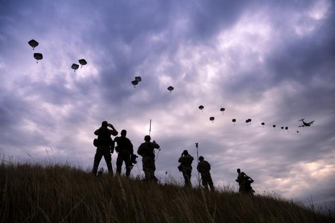NATO paratroopers drop out of a US Air Force Hercules during the 'Swift Response 17' joint airborn military exercise at Bezmer airfield near the village of Bezmer, Bulgaria, on July 18, 2017. The US led 'Swift Response 17' airborne exercise involves up to 1,600 soldiers from the United States, Canada, Italy, Portugal and Greece. (DIMITAR DILKOFF/AFP/Getty Images)