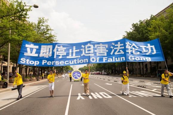 Hundreds of Falun Gong practitioners march in a parade in Washington D.C. on July 20, 2017. The parade is calling for an end to a brutal persecution in China that started on July 20, 1999. (Larry Dye/The Epoch Times)