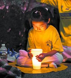 A girl attends a candlelight vigil in front of the Chinese Consulate in New York on July 16, 2017. (Benjamin Chasteen/The Epoch Times)