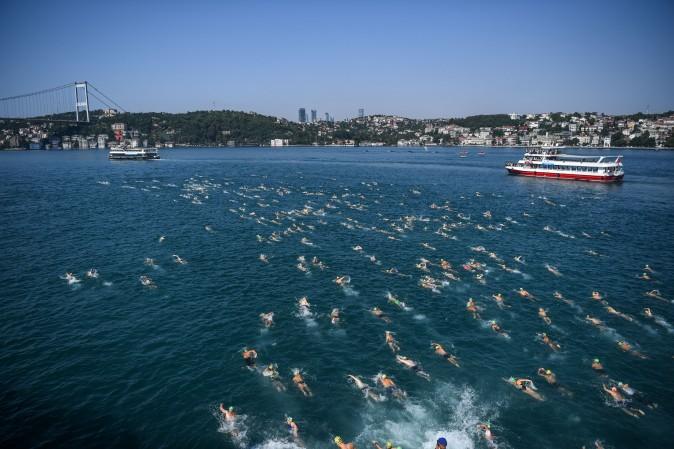 Swimmers compete in the Bosphorous river as they take part in the Bosphorus Cross Continental Swim event on July 23, 2017. The race takes participants 6 kms down the Bosphorus Strait from the Asian side of Istanbul to the European side. (OZAN KOSE/AFP/Getty Images)