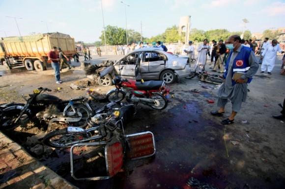 A security officer investigates the crime scene after a suicide blast in Lahore, Pakistan July 24, 2017. (Reuters/Mohsin Raza)
