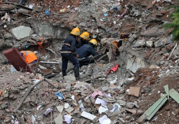 Firefighters remove debris as they search for survivors at the site of a collapsed building in the suburbs of Mumbai, India July 26, 2017. (Reuters/Shailesh Andrade)