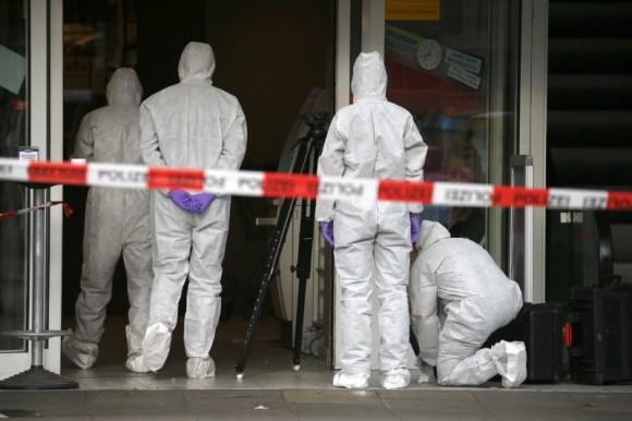 Police investigators work at the crime scene after a knife attack in a supermarket in Hamburg, Germany, July 28, 2017. (Reuters/Morris Mac Matzen)