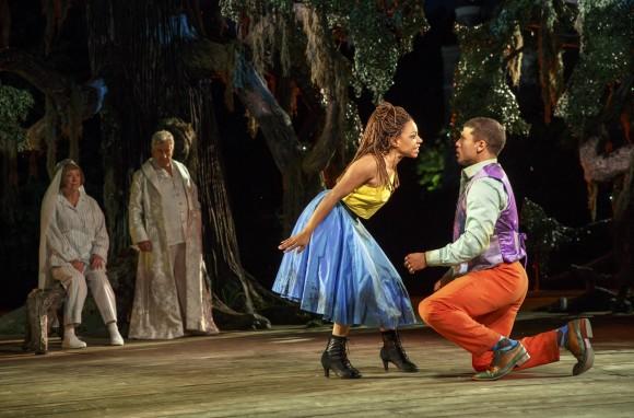 (L–R) The fairies (Kristine Nielsen and Richard Poe) watch Hermia (Shalita Grant) and Demetrius (Alex Hernandez) in the forest. (Joan Marcus)