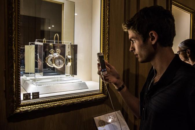 A man takes a photograph of The Calibre 89, in the Museum Room of Patek Philippe's The Art of Watches Grand Exhibition inside Cipriani 42nd Street in New York on July 19, 2017. (Benjamin Chasteen/The Epoch Times)