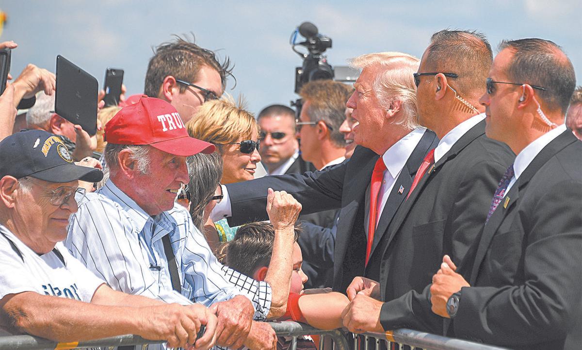 President Donald Trump greets supporters as he arrives in Springfield, Mo., on Aug. 30. (JIM WATSON/AFP/GETTY IMAGES)