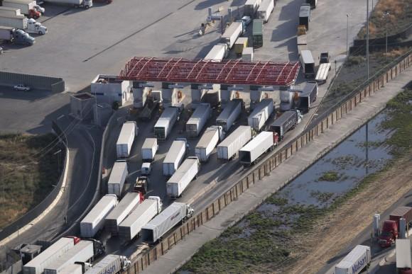 Freight trucks, as seen from a helicopter, pass through Mexican Customs before entering the United States at the Otay Mesa port of entry on May 11, 2017 in San Diego, Calif.  The border spans almost 2,000 miles from the Gulf of Mexico to the Pacific Ocean and is fenced for some 700 miles of it's total length. (John Moore/Getty Images)