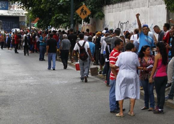 People wait in line to cast their vote during the Constituent Assembly election in Caracas, Venezuela, July 30, 2017. (Reuters/Christian Veron)