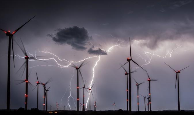 Lightnings flash over windmills of the Odervorland wind energy park near Sieversdorf, eastern Germany, on August 1, 2017. / AFP PHOTO / dpa / Patrick Pleul / Germany OUT (Photo credit should read PATRICK PLEUL/AFP/Getty Images)