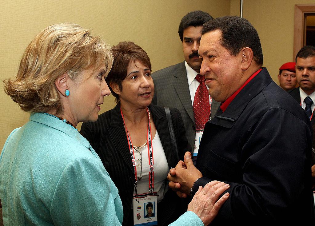 Venezuelan President Hugo Chavez (R) listens to US Secretary of State Hillary Clinton before the family picture during the Summit of the Americas at the Hyatt Regency in Port of Spain, Trinidad April 18, 2009. (PRESIDENCIA/AFP/Getty Images)