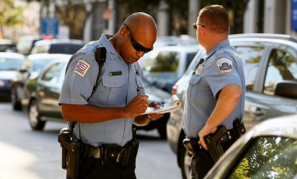 Metropolitan Police Officer Tyrone Gross (L) writes a ticket to a motorist on Sept. 21, 2010, in Washington. (Mark Wilson/Getty Images)
