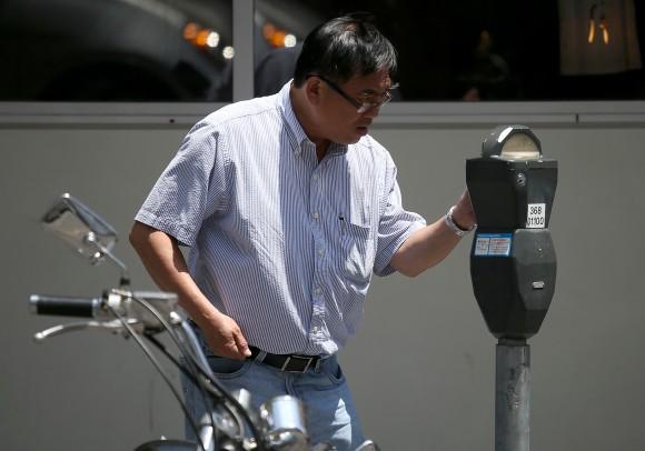 A man at a parking meter on July 3, 2013, in San Francisco, Calif. (Justin Sullivan/Getty Images)