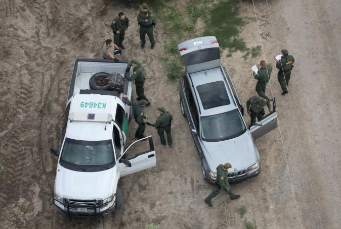 U.S. Border Patrol agents and Texas state troopers seiize bundles of marijuana during a drug bust on a BMW on March 15, 2017 in McAllen, Texas. (John Moore/Getty Images)