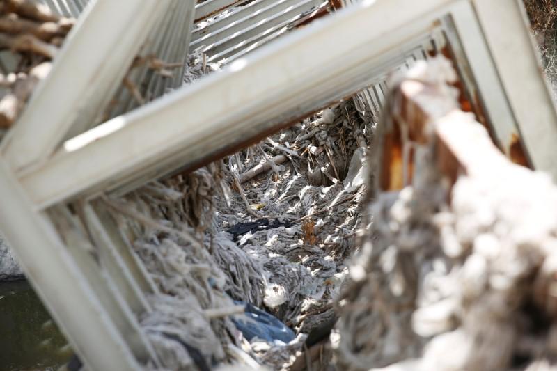 Discarded baby wipes and other garbage that flowed together with sewage are seen on a structure in the Kidron Valley, on the outskirts of Jerusalem July 6, 2017. (REUTERS/Ronen Zvulun)