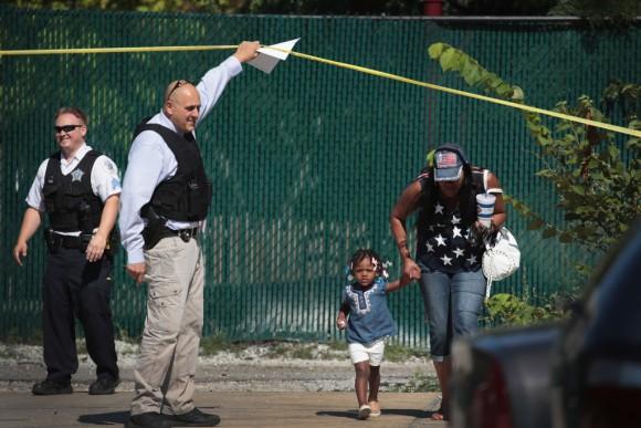 Residents are allowed to leave their home as Chicago Police investigate a murder scene in the Humboldt Park neighborhood on July 27, 2017, in Chicago, Ill. (Scott Olson/Getty Images)