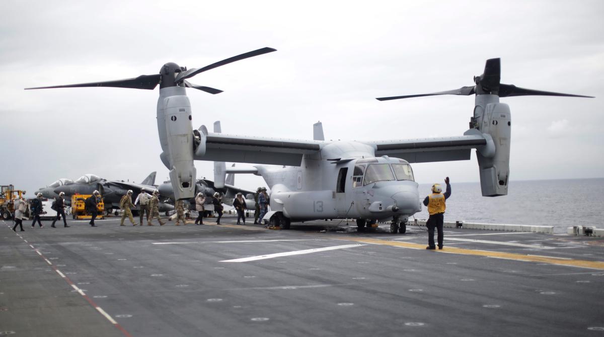 Participants in a ceremony marking the start of Talisman Saber 2017, a biennial joint military exercise between the United States and Australia, board a US Marines MV-22B Osprey Aircraft on the deck of the USS Bonhomme Richard amphibious assault ship off the coast of Sydney on June 29, 2017. (JASON REED/AFP/Getty Images)
