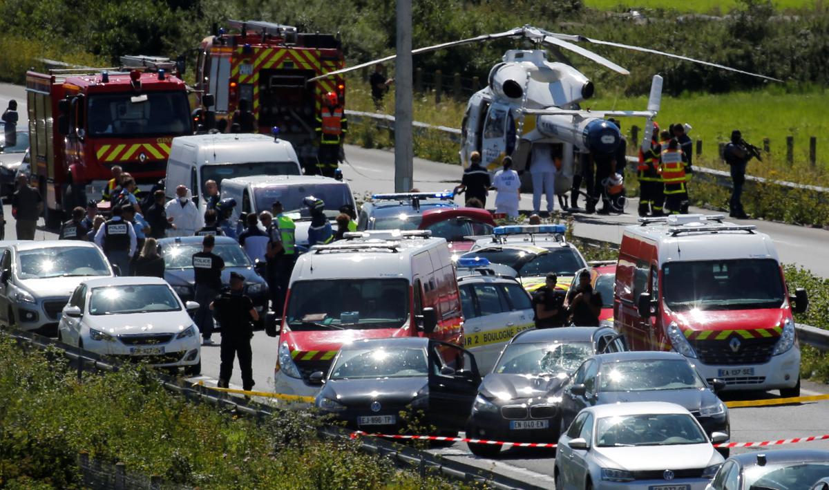 Police and rescue forces are seen on the scene where the man suspected of ramming a car into a group of soldiers on Wednesday in the Paris suburb of Levallois-Perret was shot and arrested on the A16 motorway, near Marquise, France on Aug. 9, 2017. (REUTERS/Pascal Rossignol)
