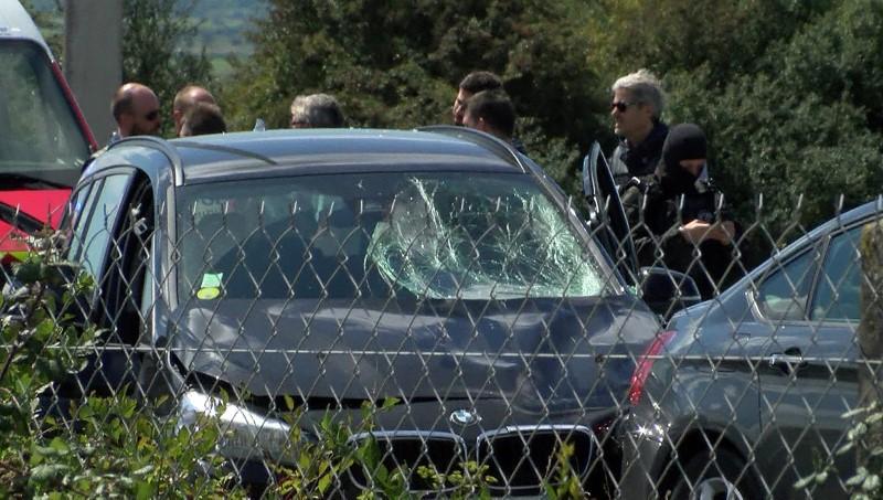 A still image taken from a video shows French police who surround a BMW car with several bullet impacts at the scene where the man suspected of ramming a car into a group of soldiers on Wednesday in the Paris suburb of Levallois-Perret was shot and arrested on the A16 motorway, near Marquise, France on Aug. 9, 2017. (REUTERS/Reuters TV)