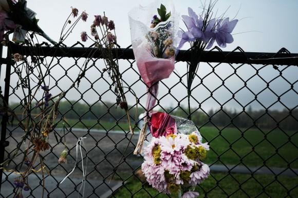 Flowers are placed along a fence near where the bodies of four young men brutally beaten by the MS-13 gang were discovered on April 28, 2017, in Central Islip, New York. (Spencer Platt/Getty Images)