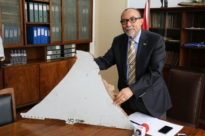 Joao de Abreu, president of Mozambique's Civil Aviation Institute (IACM), holds a piece of suspected aircraft wreckage of Flight 370 found off the east African coast in Maputo on March 3, 2016. (Adrien Barbier/AFP/Getty Images)