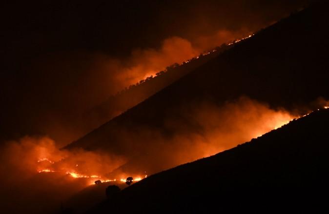 Flames and smoke rise from a forest in fire near Sarande in the Muzina mountain region, southern Albania, on Aug. 9, 2017. (GENT SHKULLAKU/AFP/Getty Images)