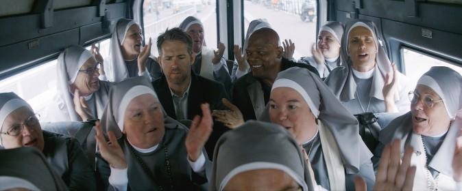 (L–R) Darius Kincaid (Samuel L. Jackson), and Michael Bryce (Ryan Reynolds) amid a plethora of nuns in "The Hitman's Bodyguard." (Summit Entertainment and Millennium Media)