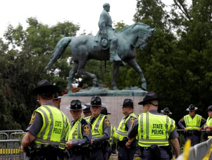 Virginia State Troopers stand under a statue of Robert E. Lee before a white supremacists rally in Charlottesville, Virginia, U.S., August 12, 2017. REUTERS/Joshua Roberts