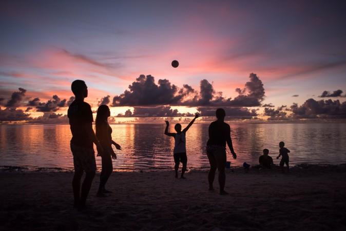 People play volleyball on a beach at Tumon Bay in Guam, on Aug. 12, 2017. (ED JONES/AFP/Getty Images)