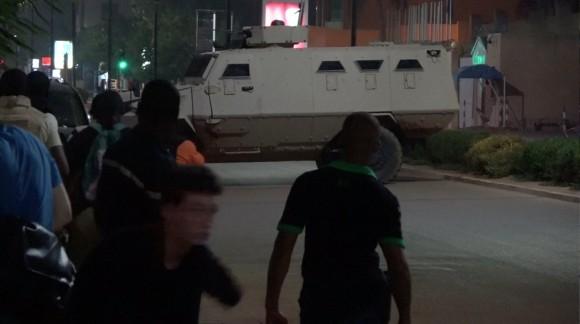 An armoured vehicle opens fire in the direction of a restaurant following an attack by gunmen on the restaurant in Ouagadougou, Burkina Faso, in this still frame taken from video August 13, 2017. (REUTERS/Reuters TV)