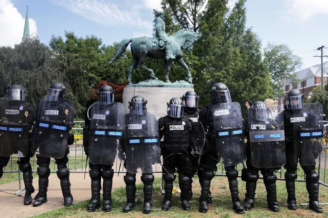 Virginia State Police in riot gear stand in front of the statue of General Robert E. Lee before forcing white nationalists, neo-Nazis and members of the "alt-right" out of Emancipation Park after the "Unite the Right" rally was declared an unlawful gathering Aug. 12, 2017 in Charlottesville, Virginia. (Chip Somodevilla/Getty Images)