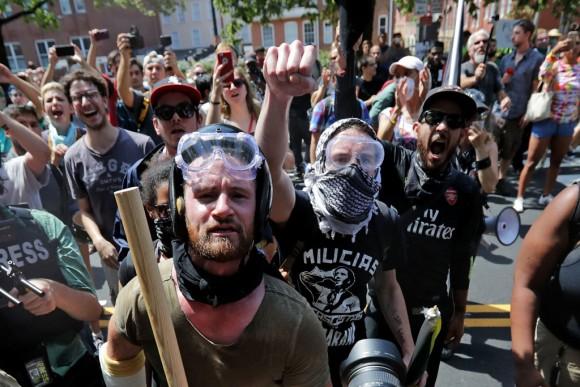 Armed members of the Antifa extremist group wait outside Emancipation Park to hurl insults as members of various groups, including white nationalists and neo-Nazis, are forced out after the Unite the Right rally was declared an unlawful gathering Aug. 12, 2017, in Charlottesville, Va. (Chip Somodevilla/Getty Images)