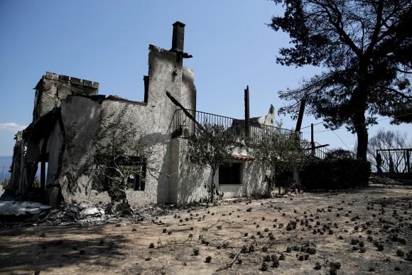 A burned house is seen following a wildfire near the village of Kalamos, north of Athens, Greece, August 14, 2017. (Reuters/Costas Baltas)