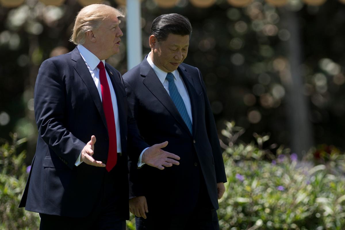 President Donald Trump and Chinese leader Xi Jinping walk together at the Mar-a-Lago estate in West Palm Beach, Fla., on April 7. (JIM WATSON/AFP/Getty Images)