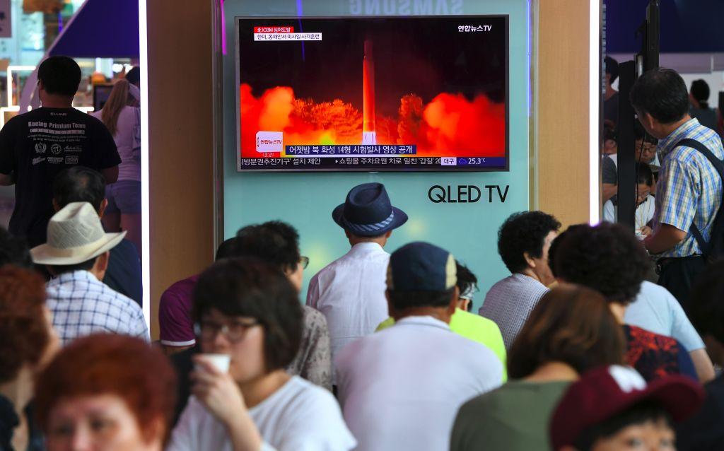 People watch a television screen showing a video footage of North Korea's latest test launch of an intercontinental ballistic missile (ICBM), at a railway station in Seoul on July 29, 2017. (JUNG YEON-JE/AFP/Getty Images)