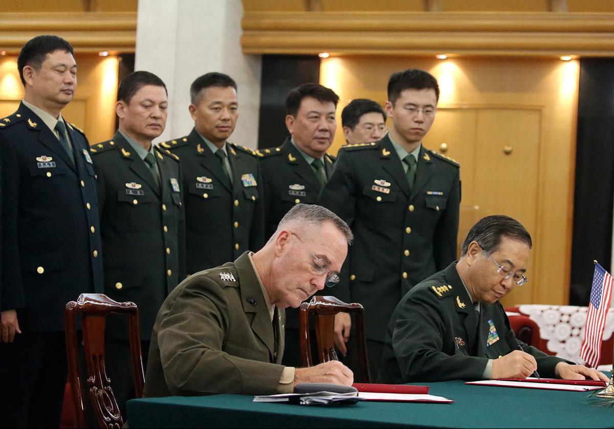 General Joseph Dunford (front L), chairman of the US Joint Chiefs of Staff, and his Chinese counterpart General Fang Fenghui, chief of the general staff of the Chinese People's Liberation Army, attend a signing ceremony in Beijing on Aug. 15, 2017. (THOMAS PETER/AFP/Getty Images)