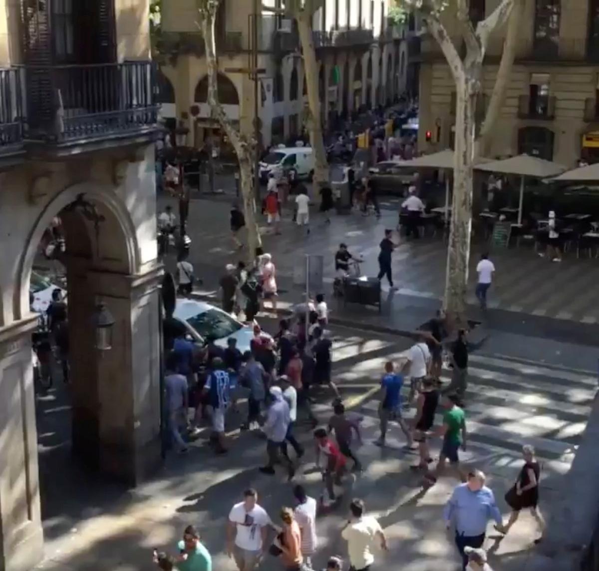 People move from the scene after a van crashed into pedestrians near the Las Ramblas avenue in central Barcelona, Spain August 17, 2017, in this still image from a video obtained from social media. (Courtesy of McKenzie Tavoda/via REUTERS)