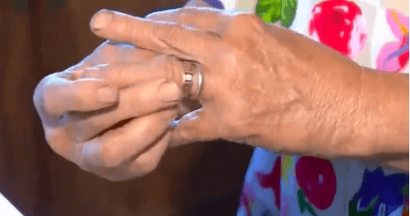 Mary Grams slips her engagement ring on her finger after missing it for 13 years. Her daughter-in-law found it growing on a carrot. (Screenshot via Reuters)