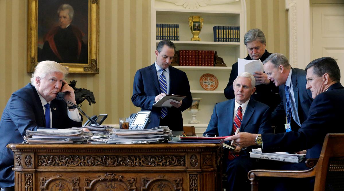 U.S. President Donald Trump is joined by (L-R) Chief of Staff Reince Priebus, Vice President Mike Pence, senior advisor Steve Bannon, Communications Director Sean Spicer and National Security Advisor Michael Flynn as he speaks by phone with Russia's President Vladimir Putin in the Oval Office at the White House in Washington, U.S. on Jan. 28, 2017. (REUTERS/Jonathan Ernst)