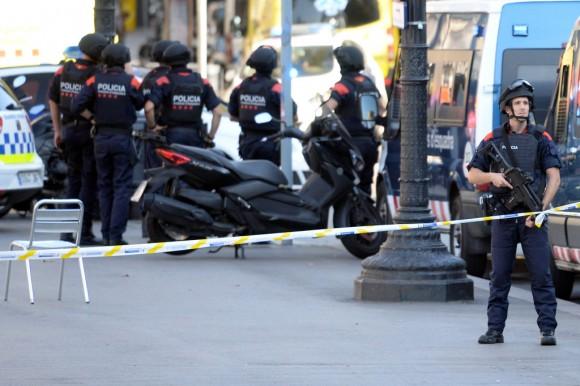 Armed policemen stand in a cordoned-off area after a van ploughed into the crowd, injuring several persons on the Rambla in Barcelona on Aug. 17, 2017. (Josep Lago/AFP/Getty Images)