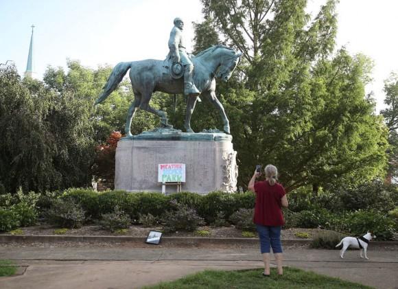 A homemade sign that says Heather Heyer Park rests at the base of the statue of Confederate Gen. Robert E. Lee that stands in the center of Emancipation Park on Aug. 18, 2017, in Charlottesville, Va. (Mark Wilson/Getty Images)