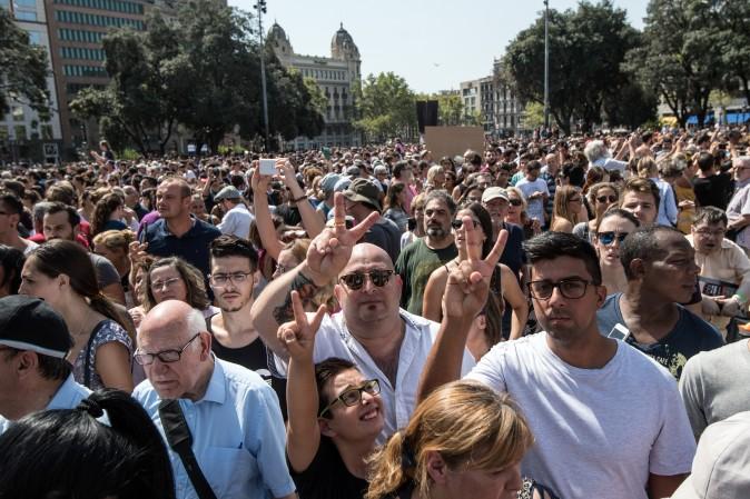 People gesture as they leave Plaça de Catalunya after observing a one minute's silence for the victims of the Aug. 17 terrorist attack in Barcelona, Spain. (Carl Court/Getty Images)