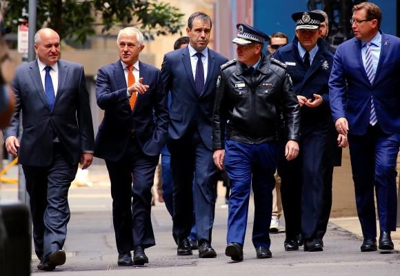 Australian Prime Minister Malcolm Turnbull walks with officials along a street before holding a media conference announcing Australia's national security plan to protect public places in central Sydney, Australia, August 20, 2017. (Reuters/David Gray)