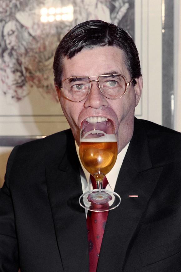 U.S. humorist, comedian, director, and singer Jerry Lewis holds a glass of beer with his mouth on Nov. 27, 1987 during a press conference in Paris. (JEAN-LOUP GAUTREAU/AFP/Getty Images)
