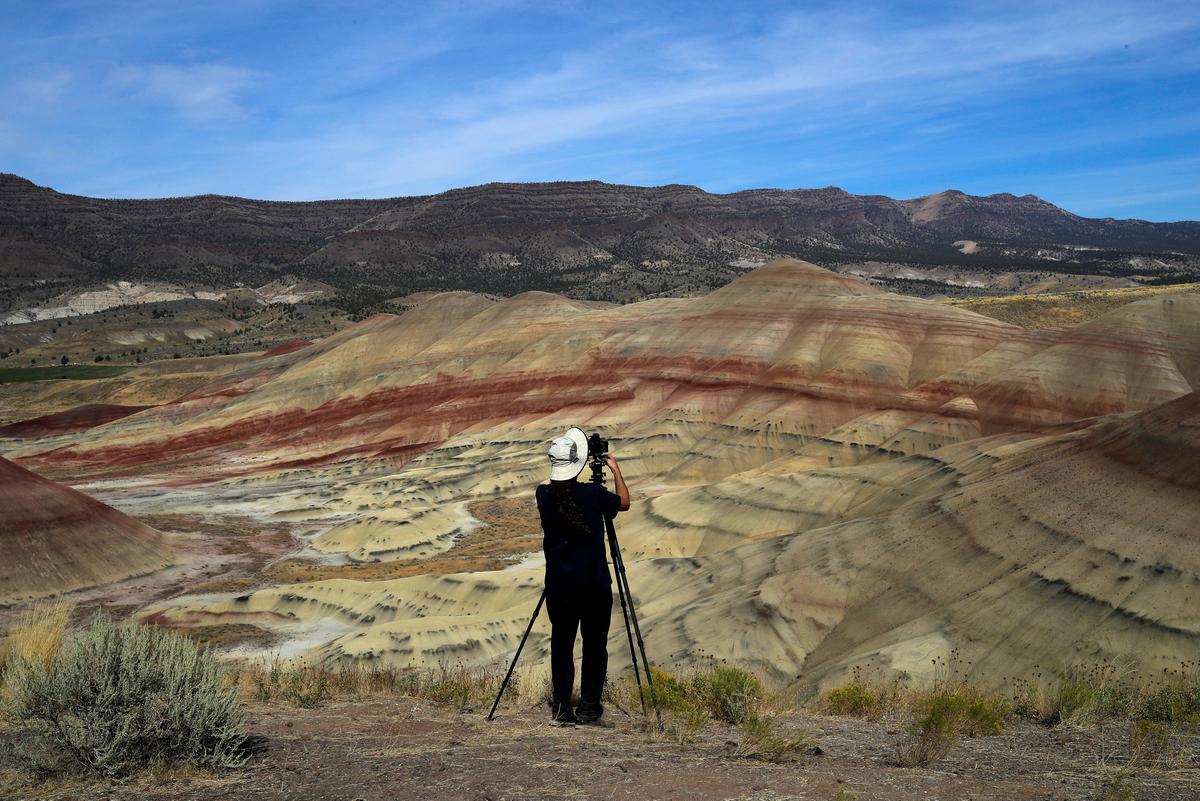 San Francisco Bay area resident Brian Martin photographs Painted Hills, a unit of the John Day Fossil Beds National Monument, in preparation for the total lunar eclipse near Mitchell, Oregon, U.S. August 20, 2017. (REUTERS/Adrees Latif)