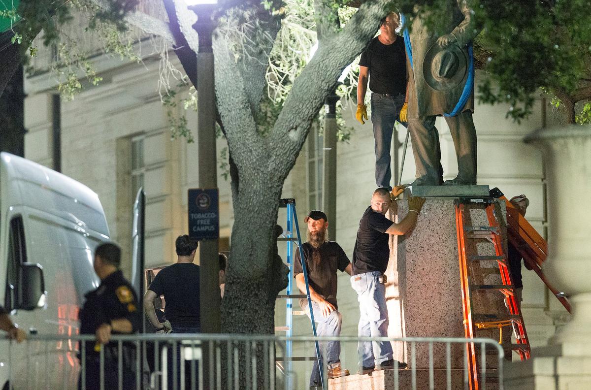 Workers remove Confederate Postmaster General John Reagan's statue from the south mall of the University of Texas in Austin, Texas, on Aug. 21, 2017. (Stephen Spillman/Reuters)
