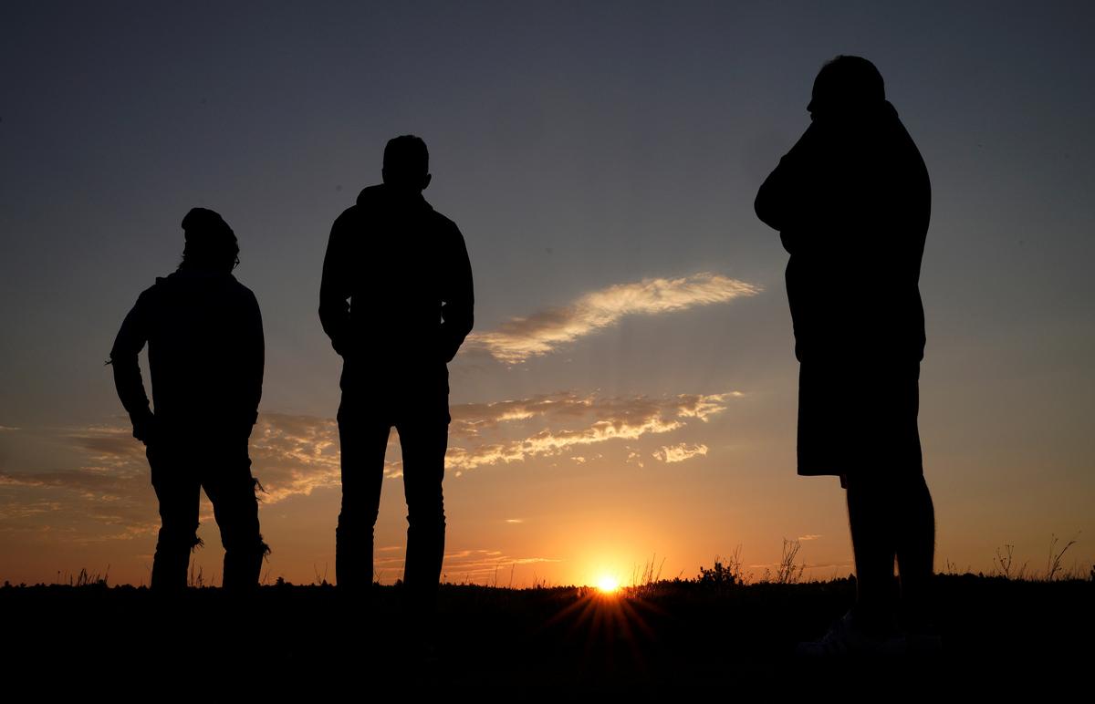 People wait for the solar eclipse as they watch the sunrise in Guernsey, Wyoming, U.S. August 21, 2017. (REUTERS/Rick Wilking)