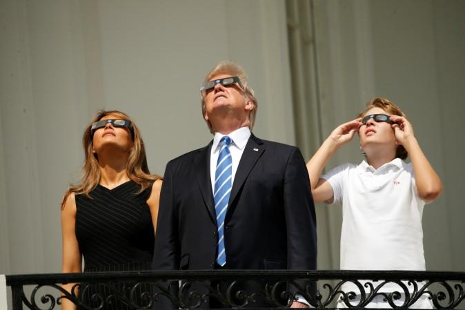 President Donald Trump watches the solar eclipse with first Lady Melania Trump and son Barron from the Truman Balcony at the White House on Aug. 21, 2017. (Kevin Lamarque/Reuters)