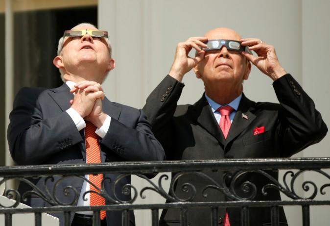 U.S. Attorney General Jeff Sessions (L) and Commerce Secretary Wilbur Ross watch the solar eclipse from the Truman Balcony at the White House on Aug. 21, 2017. (Kevin Lamarque/Reuters)