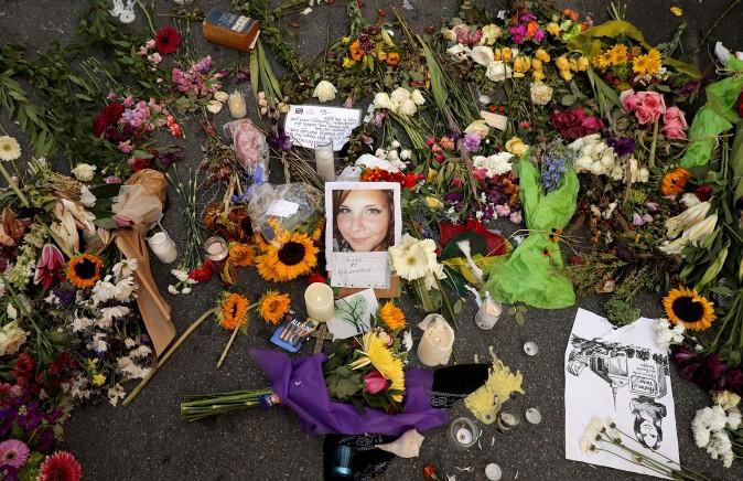 Flowers, candles, and chalk-written messages surround a photograph of Heather Heyer on the spot where she was killed and 19 others injured when a car slammed into a crowd of people protesting against a white supremacist rally, Aug. 16, 2017 in Charlottesville, Virginia. (Chip Somodevilla/Getty Images)